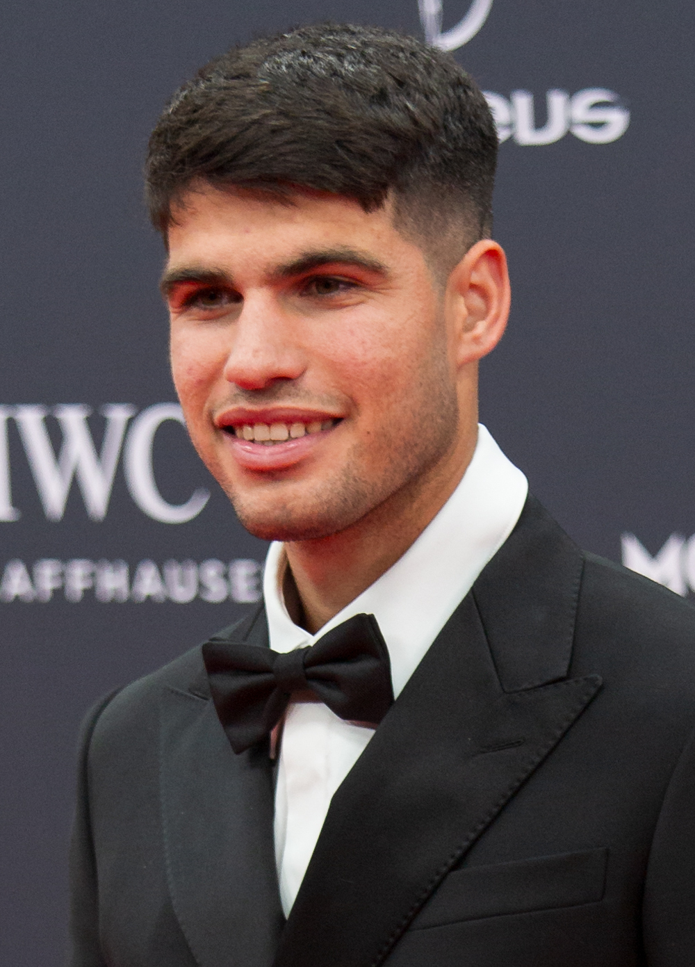 Carlos Alcaraz, the rising Spanish tennis sensation, showcases his youthful charisma on the red carpet at the 25th Laureus World Sports Awards in Madrid.