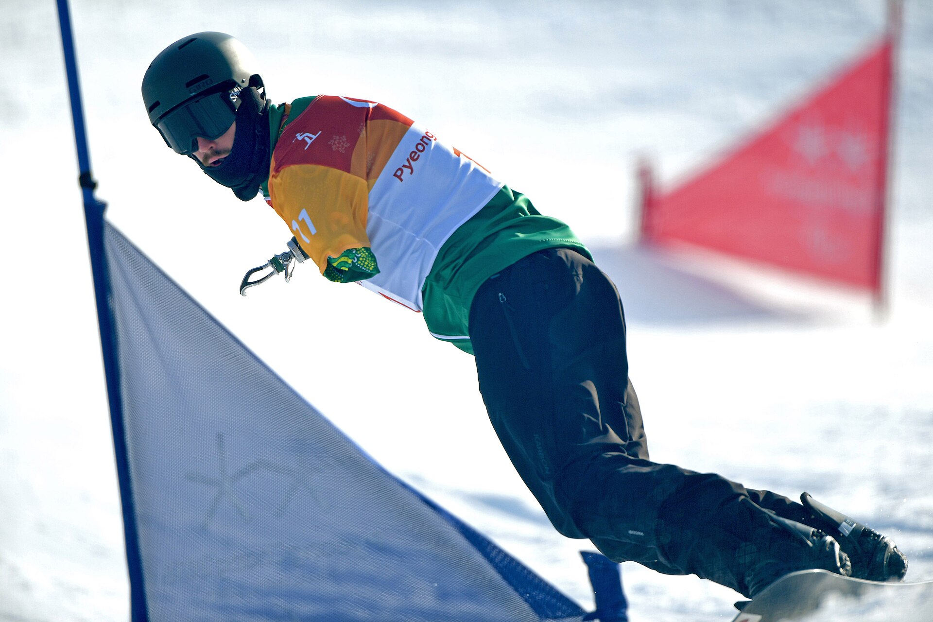 Sean Pollard competes in the men's snowboard banked event on Day 2 at the 2018 Paralympic Games. This image was taken by the official Australian team photographer at the 2018 winte