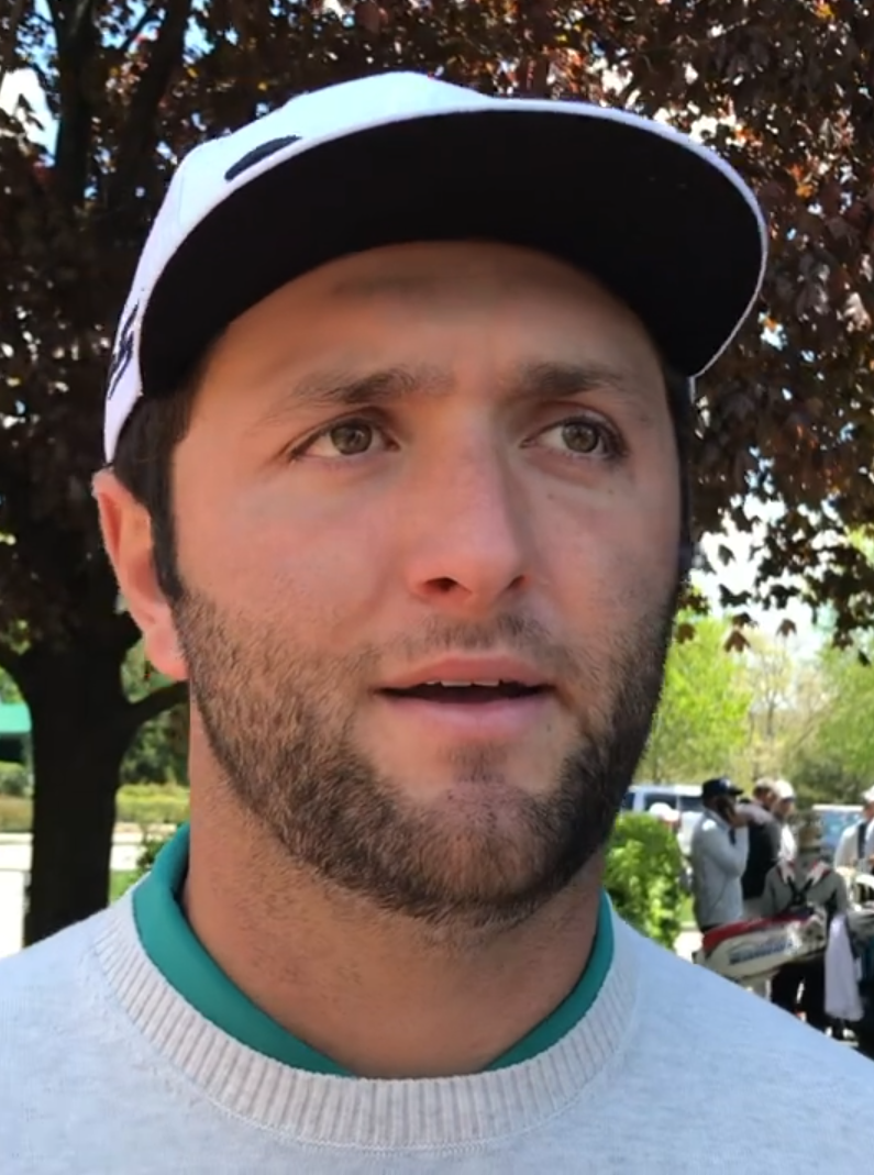 Jon Rahm looking slightly off camara while being interviewed. This screenshot is from approximately 0:23 of the source video.