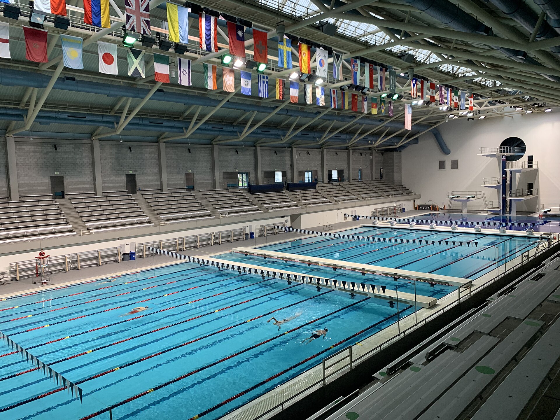 Competition natatorium with bleacher-lined competition pool and diving well with diving tower at King County Aquatic Center on 23 November 2022.I, Tanis Coralee Leonhardi, took thi