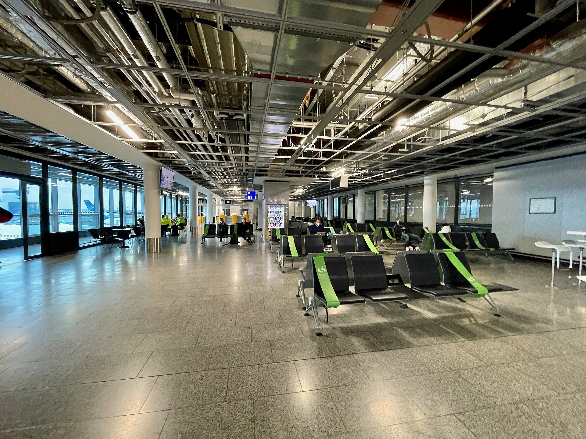 In the outer side of the concourse, inner toward the main building